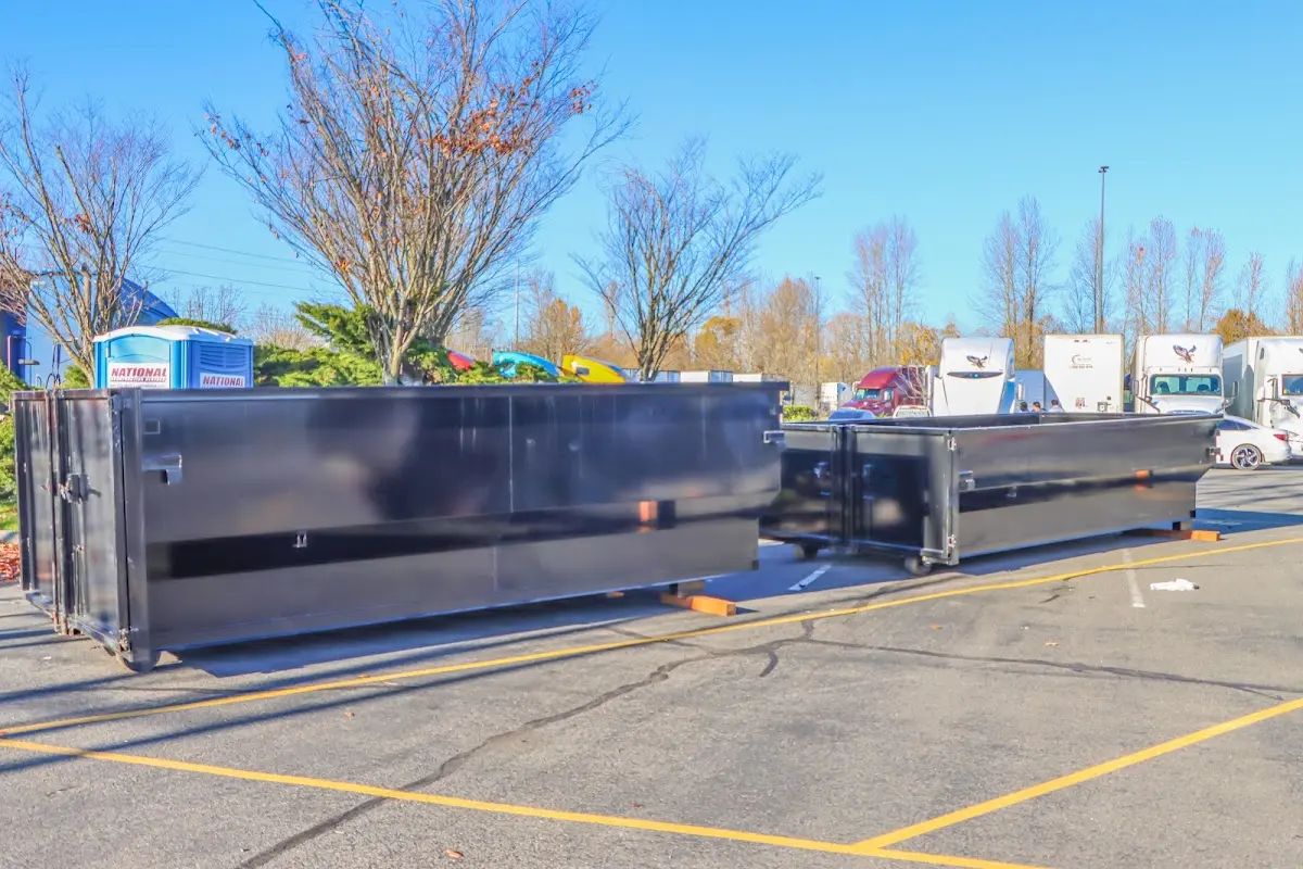 Professional dumpster rental service with roll-off container on residential driveway in Golden